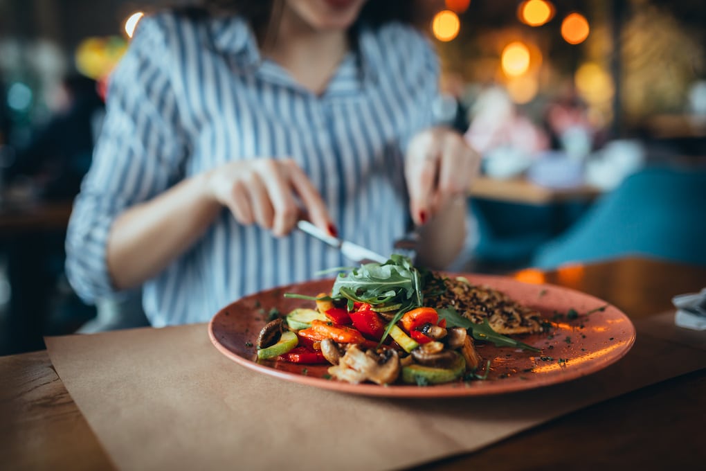 close up of woman in restaurant in acton, ma eating