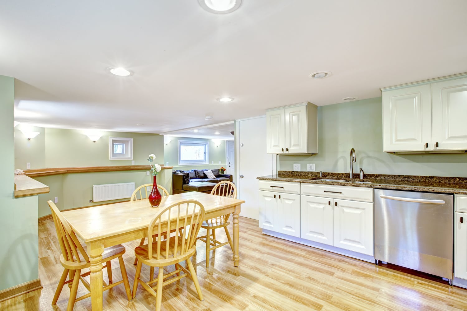 multigenerational homes light mint green basement with kitchen and dining area